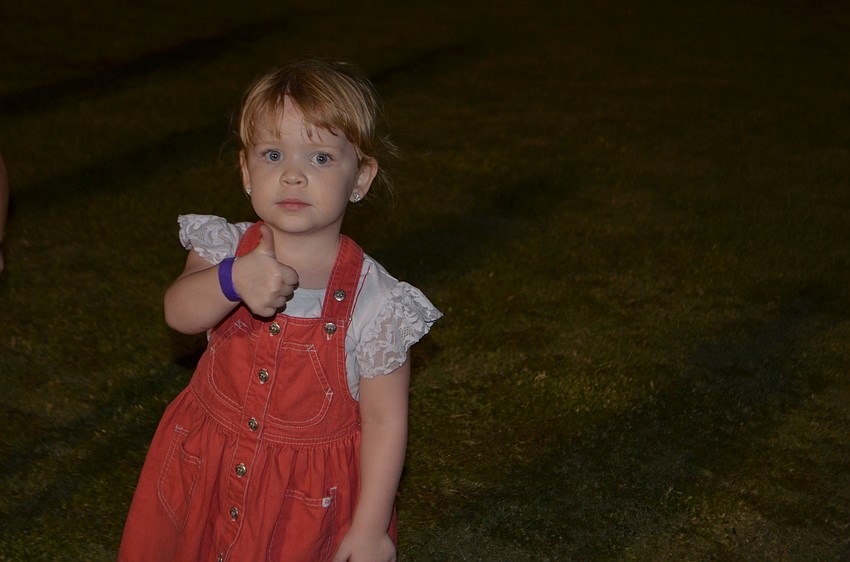 Ellington's Presley Briggs, 3, gives a thumbs up as she twirls at the YMCA's Fall Festival.