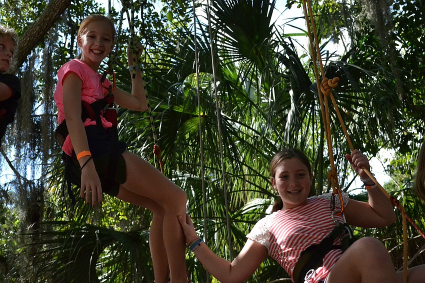 Kendall Dooley and Maxine Temple sit high in the trees.