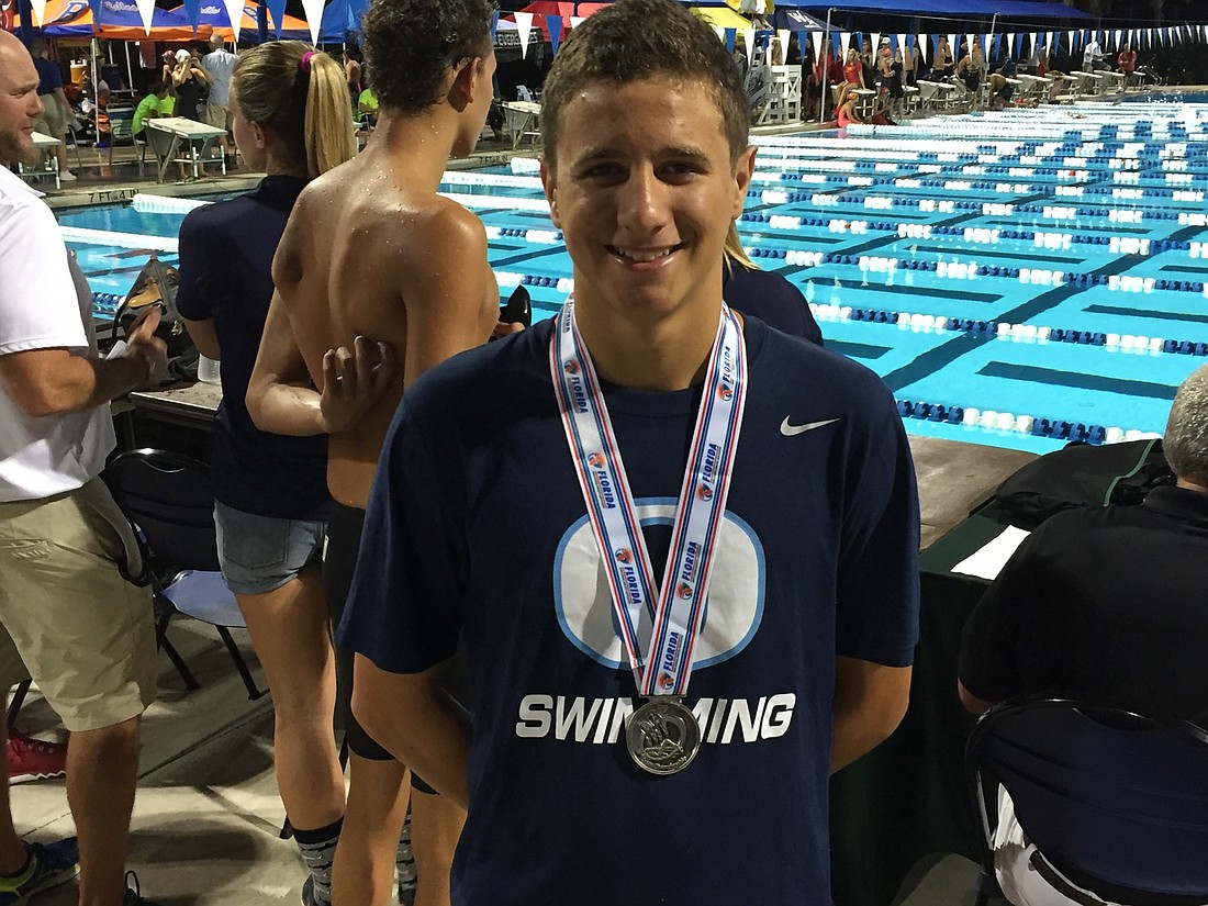 Out-of-Door Academy junior swimmer Martin Baffico shows off his gold medal.