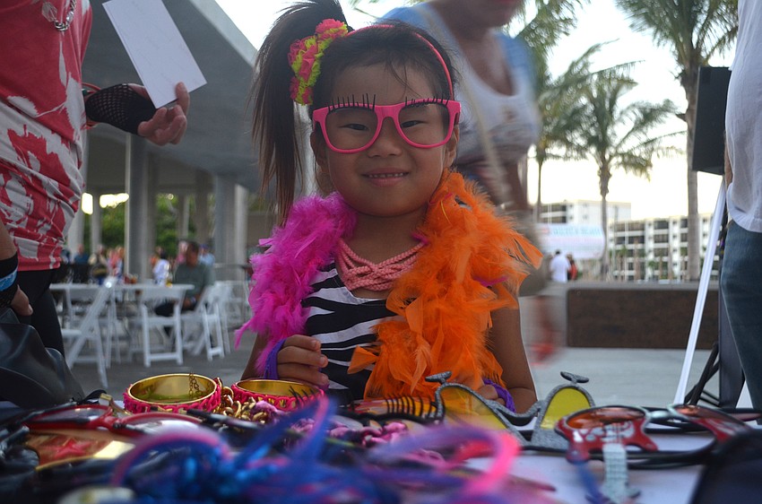 Chloe Light found a rad pair of glasses to match her pink leg warmers at the photo booth during Sandfest.