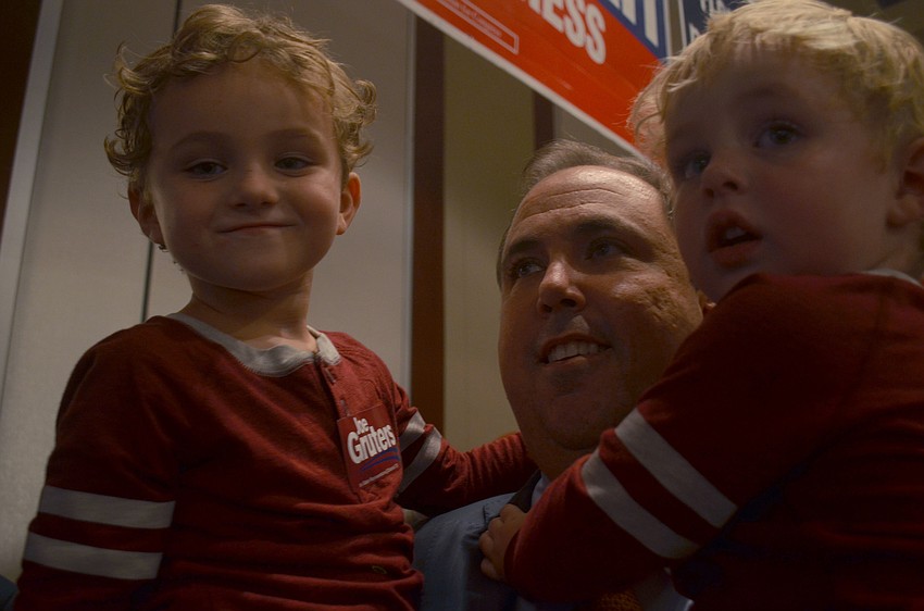 Joe Gruters holds his sons before thanking supporters for his win in the District 73 House of Representative seat.