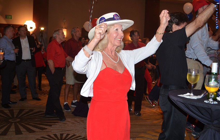 Debby Rossi celebrates Donald Trump's early gains in the presidential election.