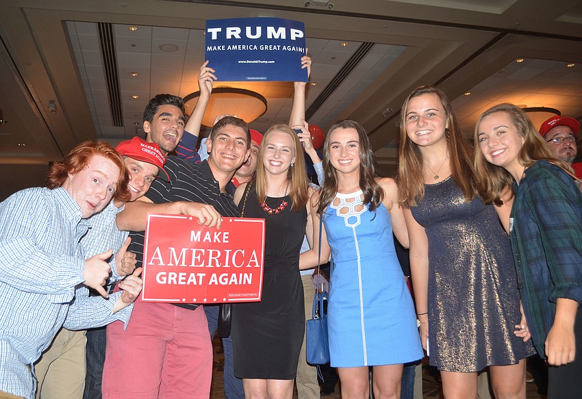 A group of Trump supporters poses after celebrating earlier gains for their candidate.