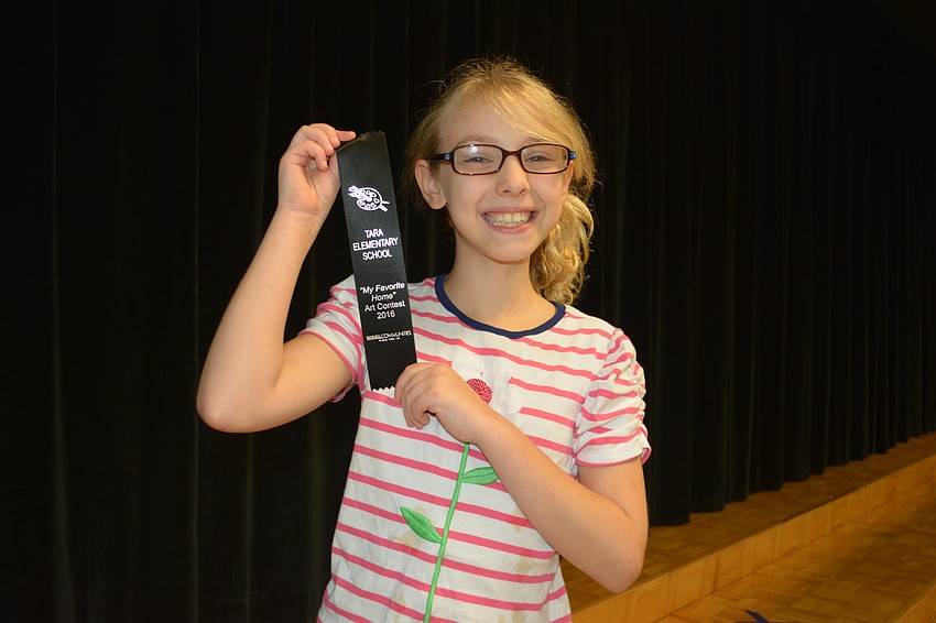 Lillian Bodenhorn shows off her ribbon for winning the third-grade division.