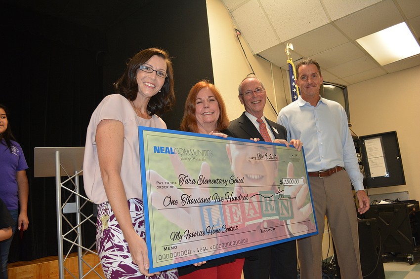 Principal Laura Campbell, art teacher Pat Knowlton, Pat Neal and Vice Principal Mike Kelley get to check it out.