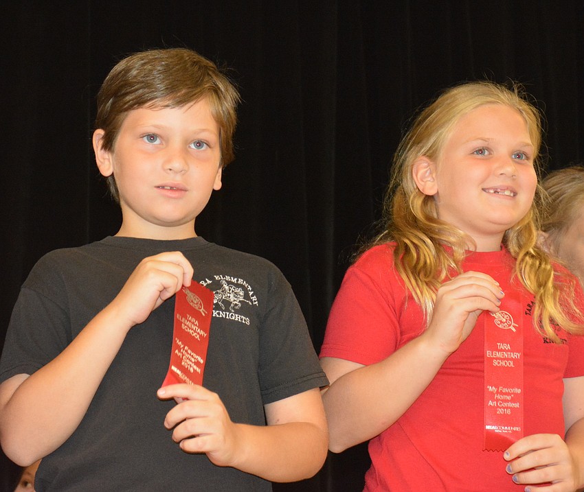 Second-graders Gregory Papp and Ella Rodgers prove it is a red ribbon day.