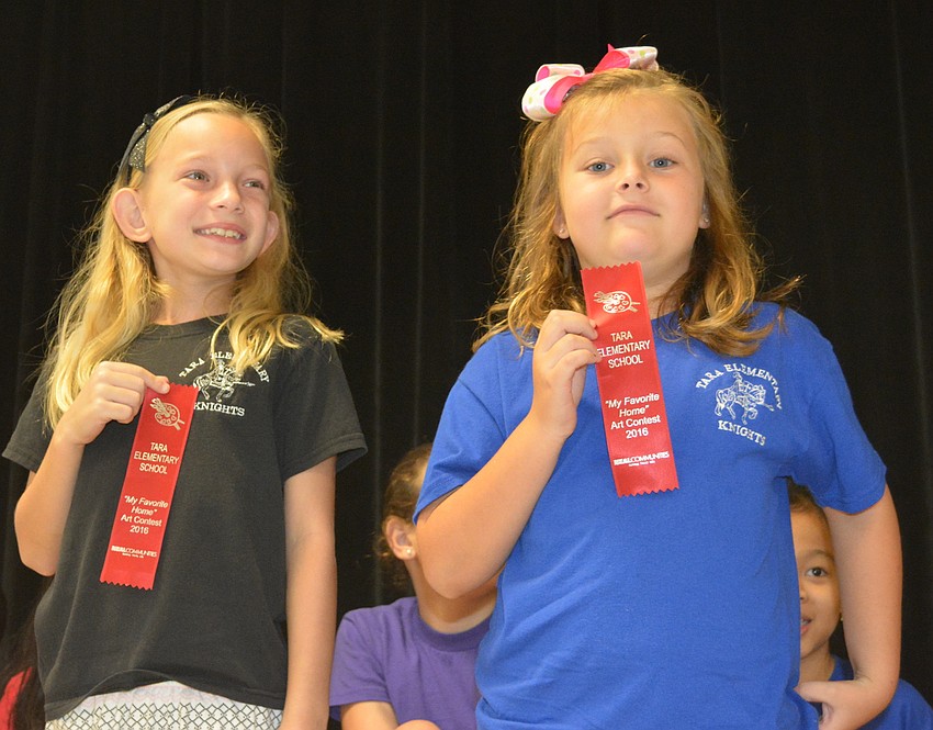 Alayne Freier and Zoe Ogden show their reward for their artistic talents.