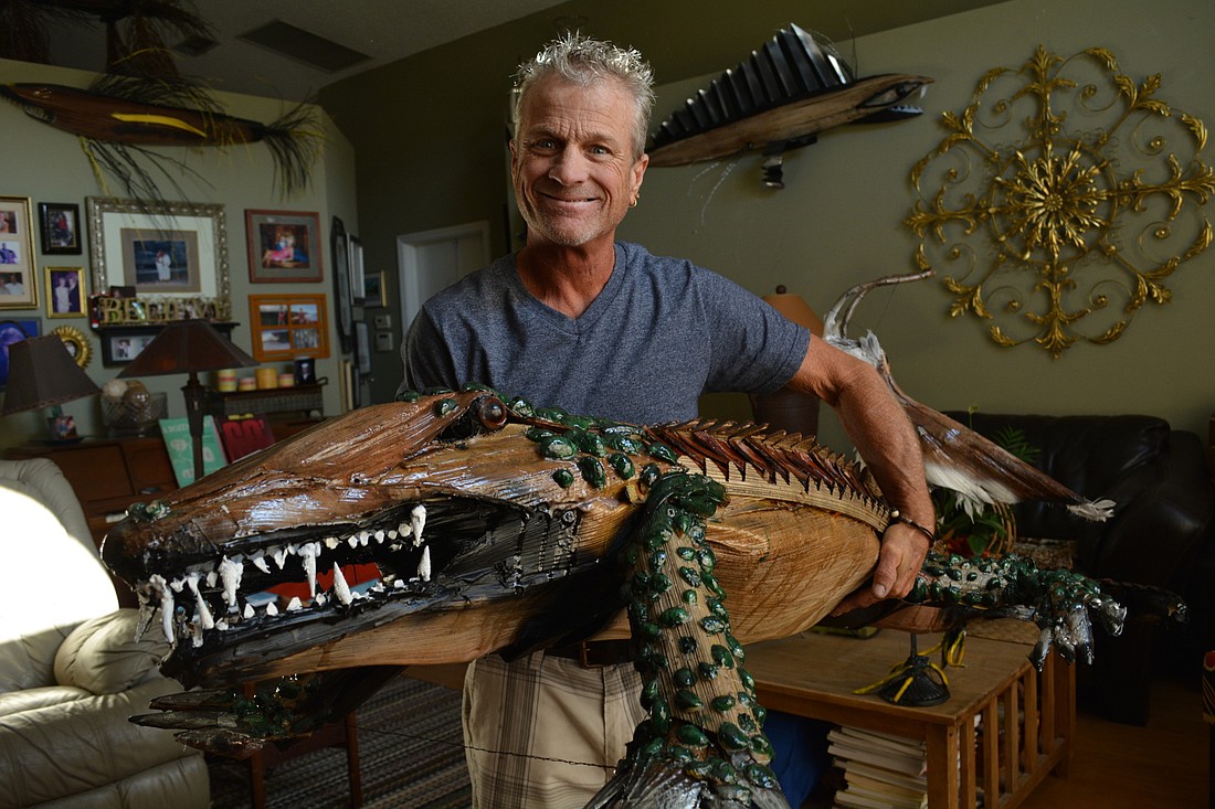 David Skaggs recently completed this 6-foot-long gator with shells he found on Siesta Key Beach. He looked for specific shapes of palm fronds for six months before finding the perfect pieces to use.