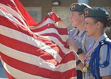 Lakewood Ranch High JROTC color guard members Jennifer Gaffers, a senior, and Kaley Gee, senior, present the colors.