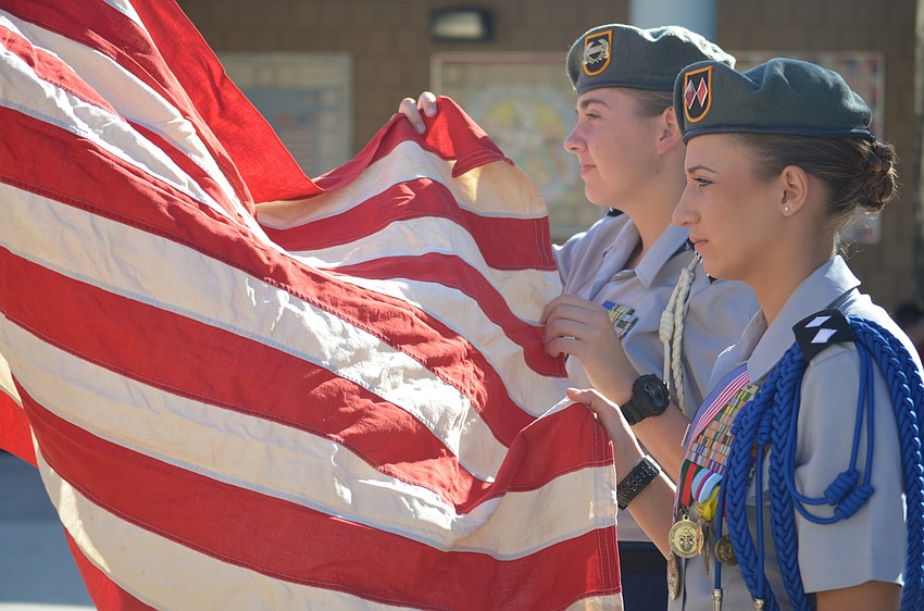 Lakewood Ranch High JROTC color guard members Jennifer Gaffers, a senior, and Kaley Gee, senior, present the colors.
