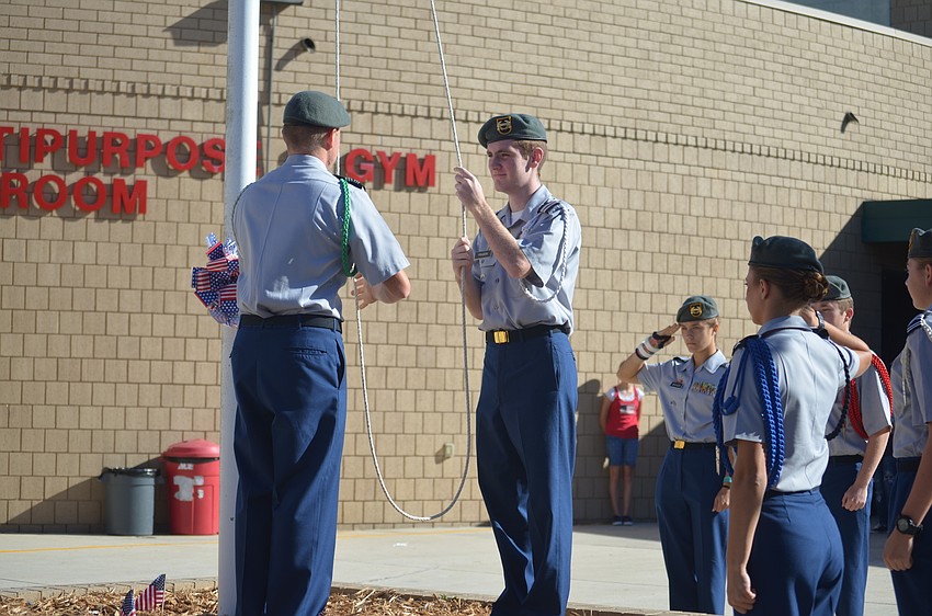 Thomas Fraser, a Lakewood Ranch JROTC senior, raises the flag.