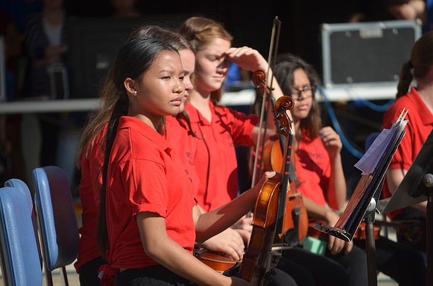 Braden River Middle School seventh-grader Katelyn Nugya waits for her chance to play the violin at her school's Veterans Day ceremony.