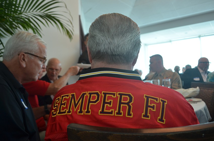 Thomas Burneston sits at a table with fellow Marines during the 14th annual Marine Birthday Celebration at Marina Jack. The event commemorated the 241st anniversary of the Marine Corps.