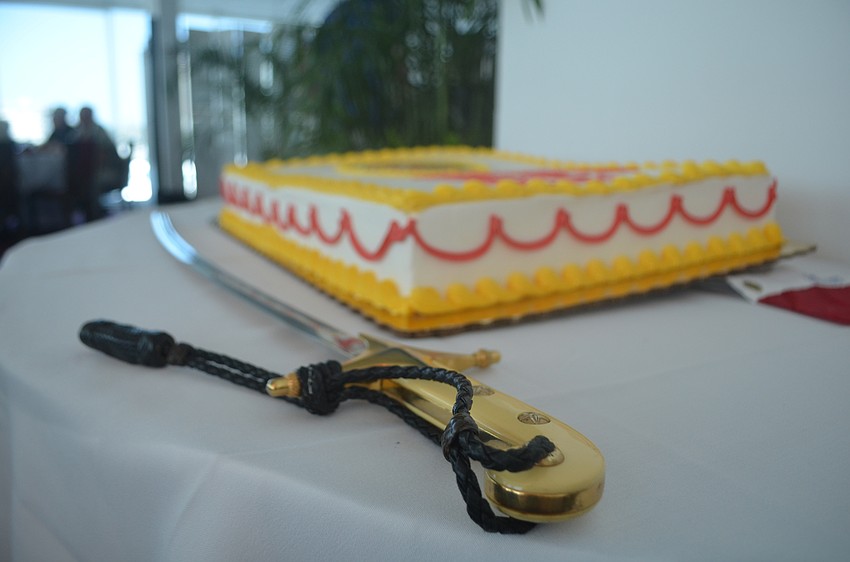 A saber sits by the Marine Corps birthday cake before it was cut. Cutting the cake with a saber is a tradition at the celebration.