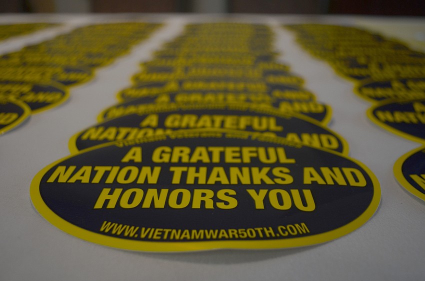 Stickers commemorating the service of Vietnam veterans lined the table outside the ballroom.