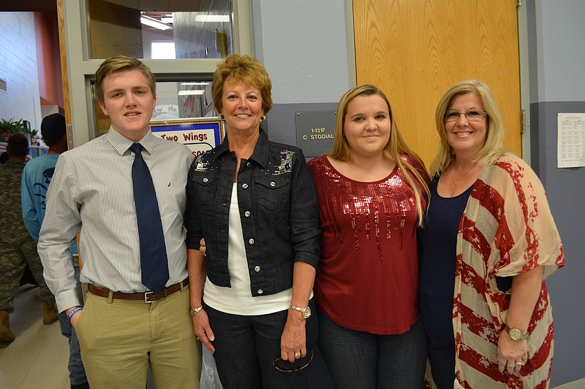 Logan Cagle, a high school senior, greets an old teacher from Freedom, Debbie Steube, with his sister, Lindsey, and mom, Sharri. Sharri Cagle, who now lives in Tampa, led efforts to create Freedom's courtyard and annual ceremony.
