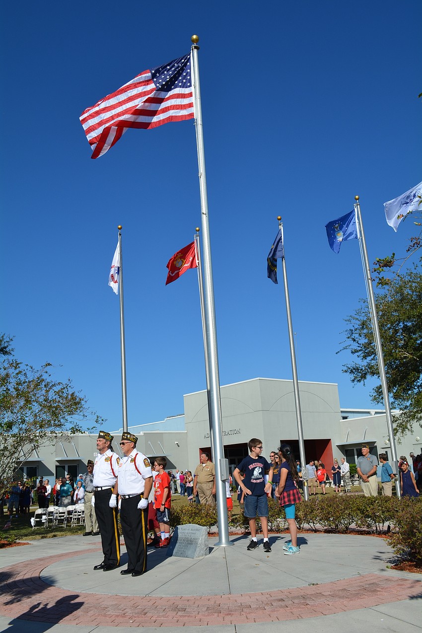 Children and veterans raised the American flag and military and first responder flags during the courtyard ceremony portion of the program.
