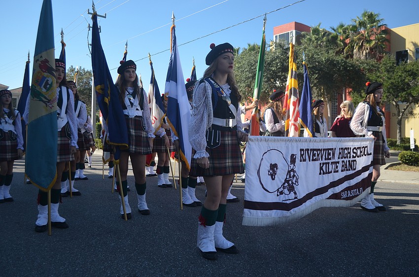 Members of the Riverview High School Kiltie Band wait on Links Avenue before the Veterans Day Parade.