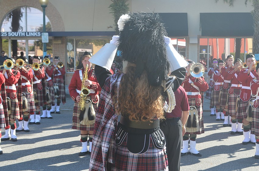 Riverview High School senior Meredith Housh directs the Riverview High School band while the band warmed up before the parade.