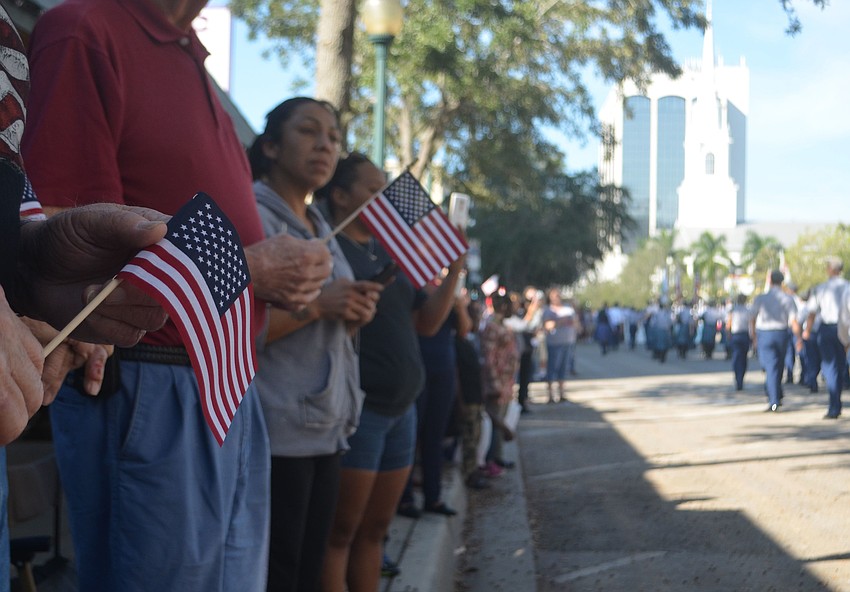 Paradegoers lined the streets, waving American flags while watching the parade on Main Street.