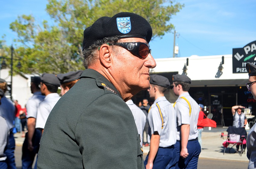 Army veteran Col. Larry Gatt watches as Sarasota Military Academy cadets march in Sarasota's Veterans Day parade.