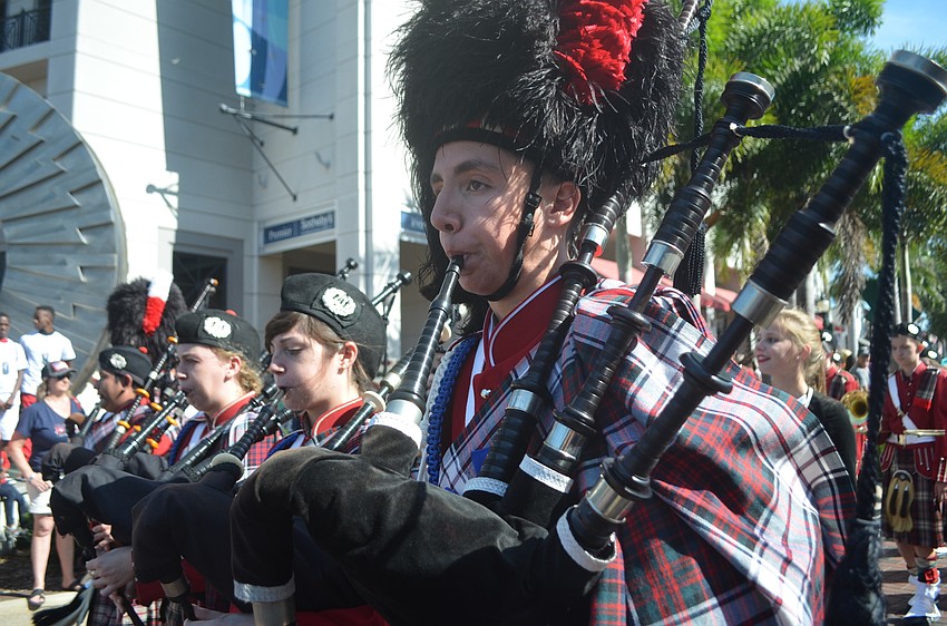 Members of the Riverview High School Kiltie Band play the bag pipes in the parade.