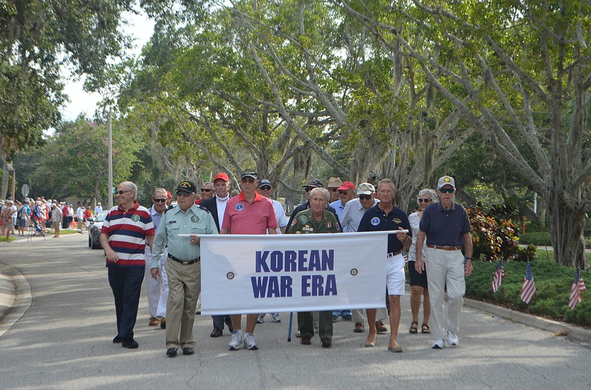 Korean War era veterans make their way through the quarter-mile parade route.