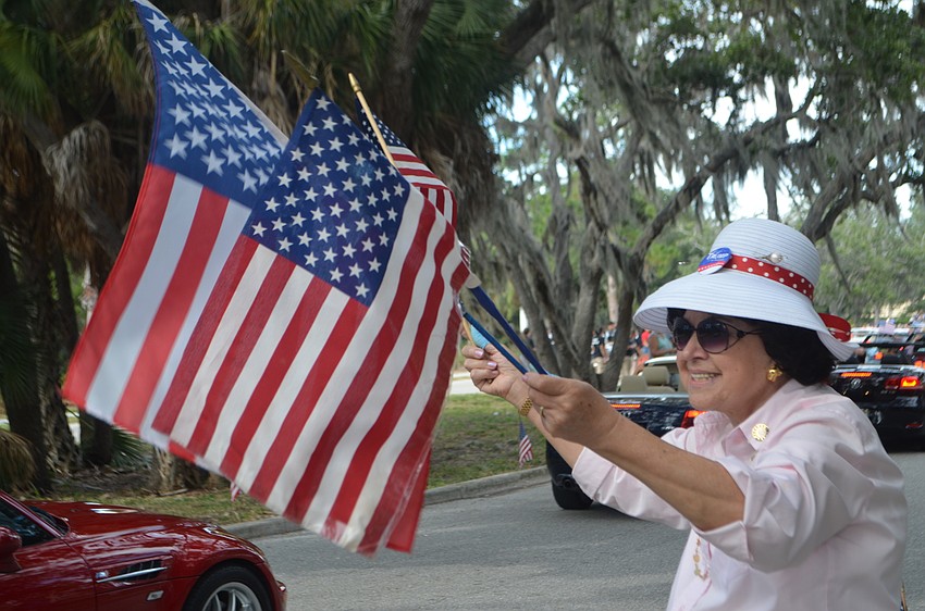 Lilly Garcia waves American flags during Longboat Key’s third annual Veterans Day Parade on Nov. 11.