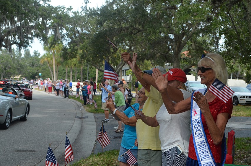 Family and friends of veterans wave to their loved ones during Longboat Key’s third annual Veterans Day Parade.