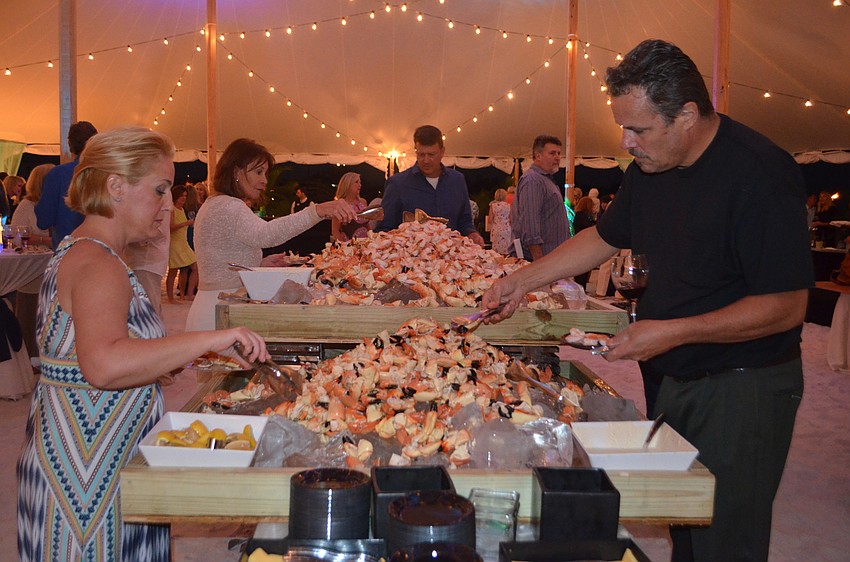 Guests enjoy stone crab during the sixth annual Bacchus on the Beach on Nov. 11.