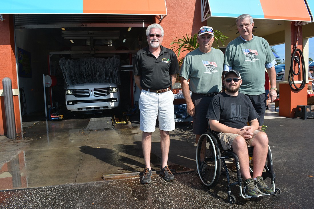 Clear Sunset Car Wash owner Tony Milen, volunteers Jim Kehoe and John Skelton and disabled vet Carl Moore III get together during the Veterans Day special.