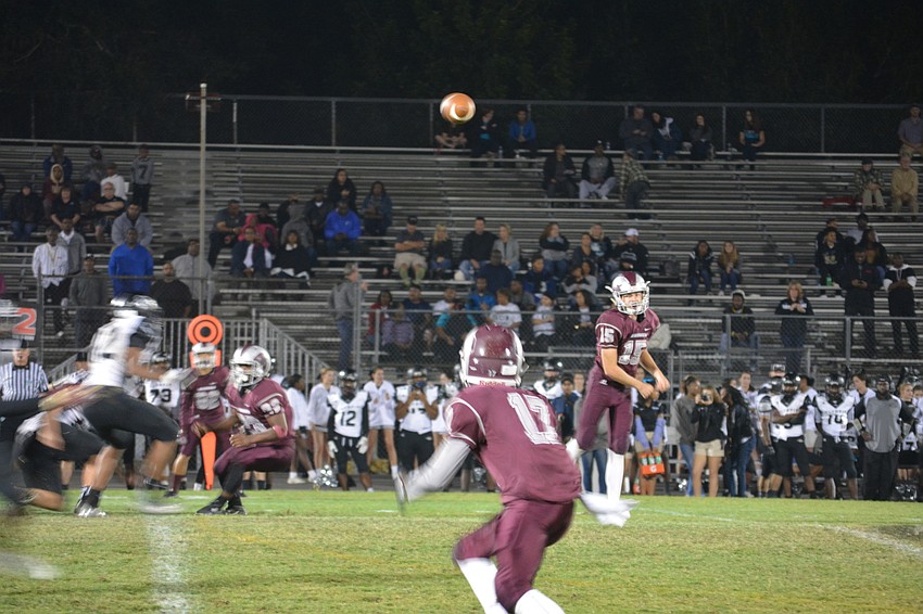 Riverview sophomore quarterback Max Fisher throws a screen pass to freshman wideout Samari Smith in the second half of the Rams' 56-25 playoff win over Olympia.