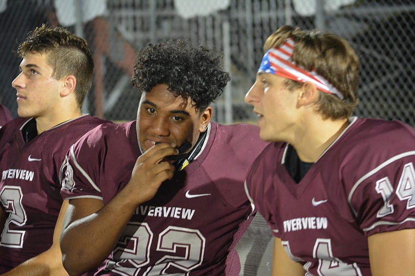 Riverview sophomore running back Ali Boyce adjusts his mouthpiece while chatting with senior wide receiver Mike Van Ness. The Rams beat Olympia 56-25.
