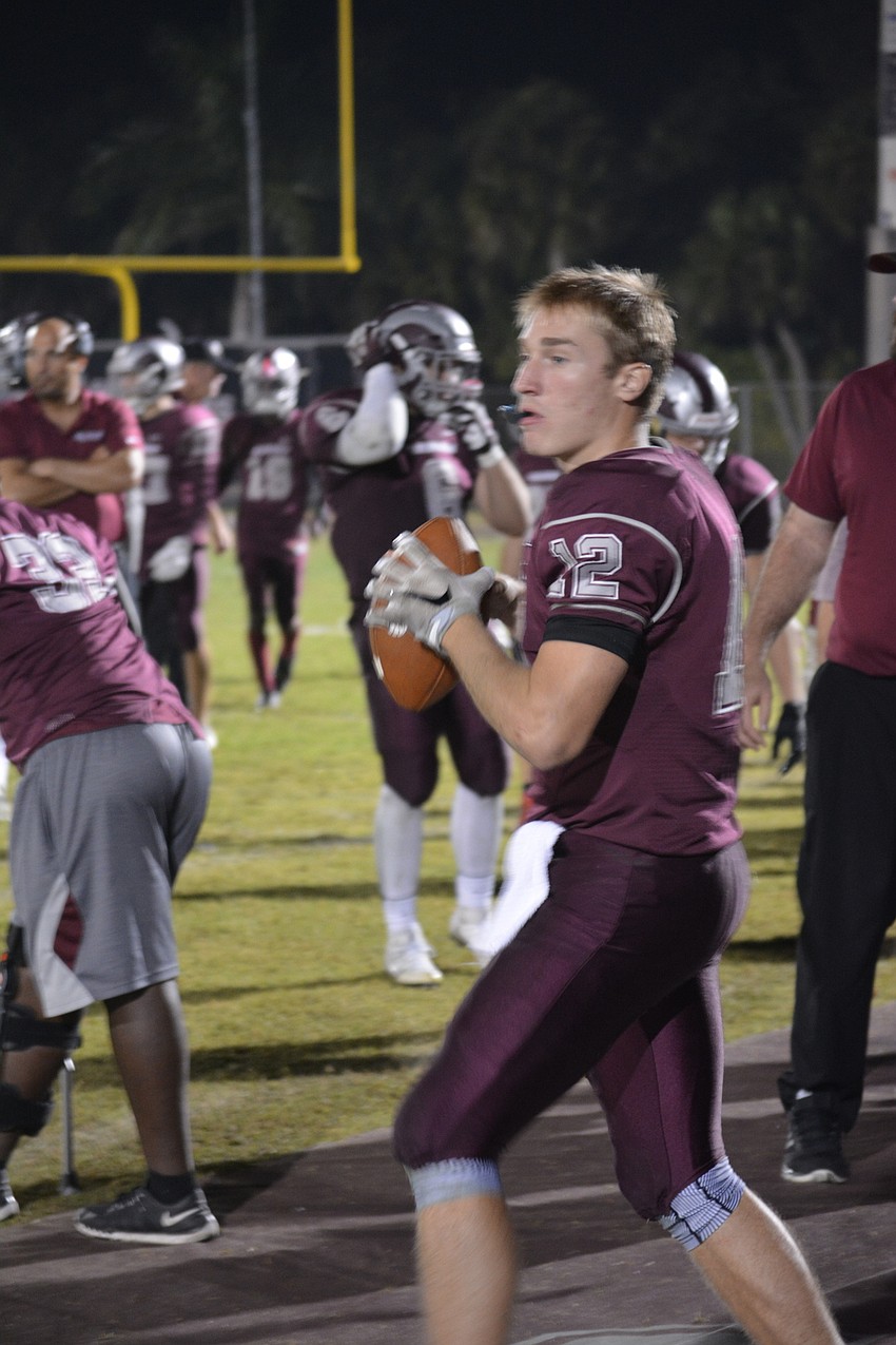 Riverview senior quarterback Mike Welcer warms up before the second half of his team's 56-25 playoff win over Olympia