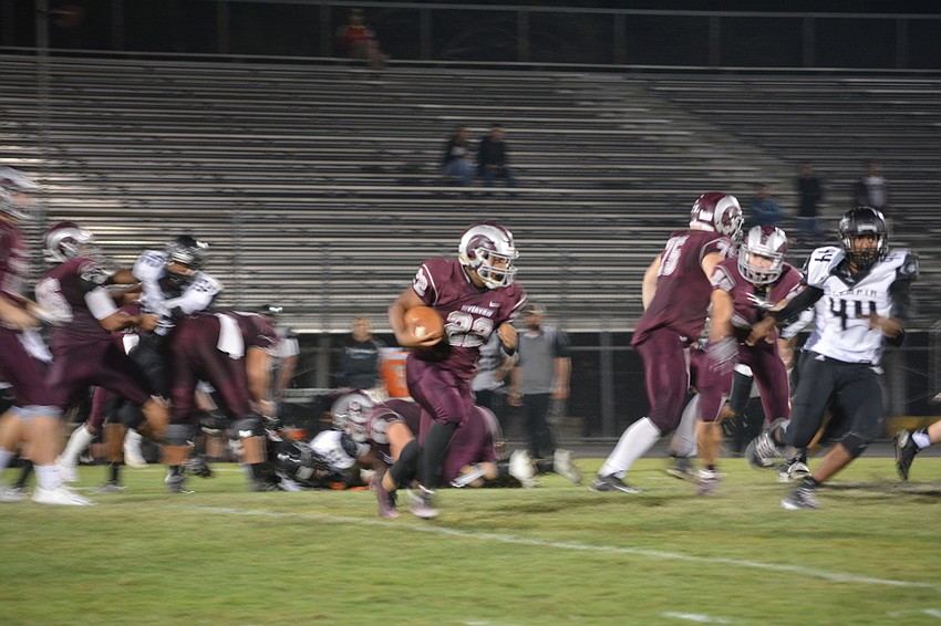 Sophomore running back Ali Boyce runs through the Olympia defense in his team's 56-25 win on Nov. 11.