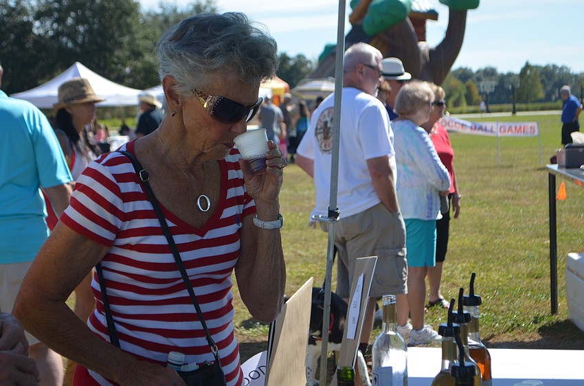Osprey's Mary Lou Ferrari sniffs some red wine before tasting it at Festa Italiana.