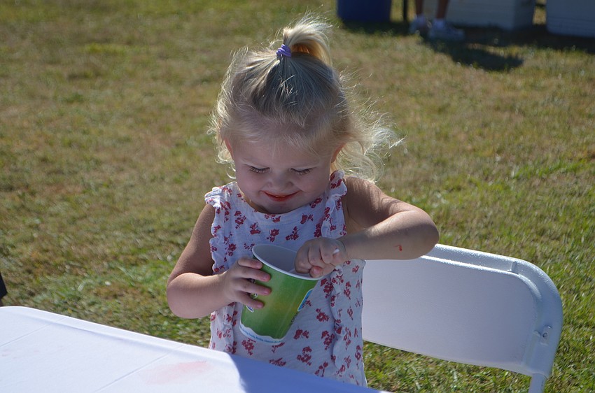 Lakewood Ranch's Grace Gillooly, 2, concentrates on her red slushy.