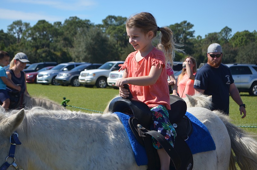 Siesta Key's Francesca DiSilvio, 3, takes a ride on an Italian horse.