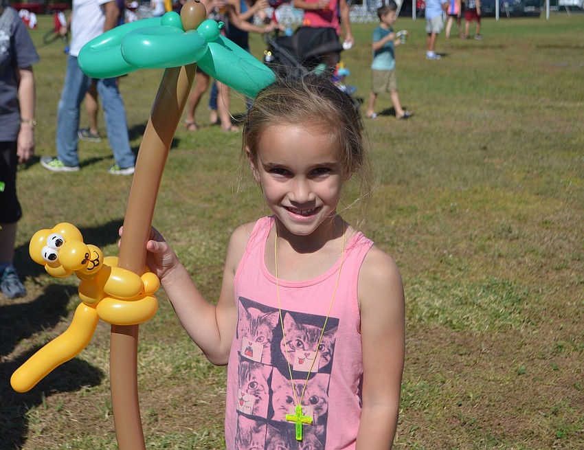 Country Club's Mila Nelson, 7, enjoys her monkey balloon.