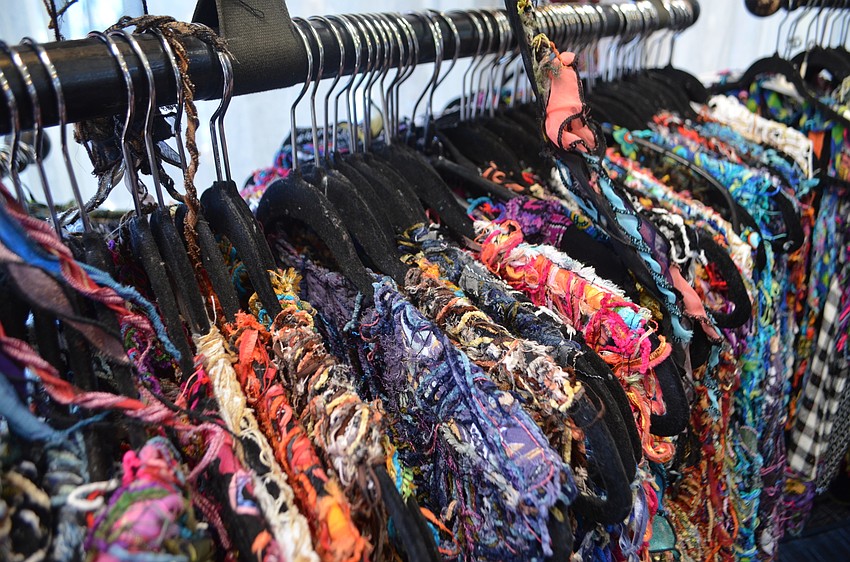 Clothing from Handmade Chenille rests on hangers during the St. Armands Art Festival on Nov. 12 and 13.