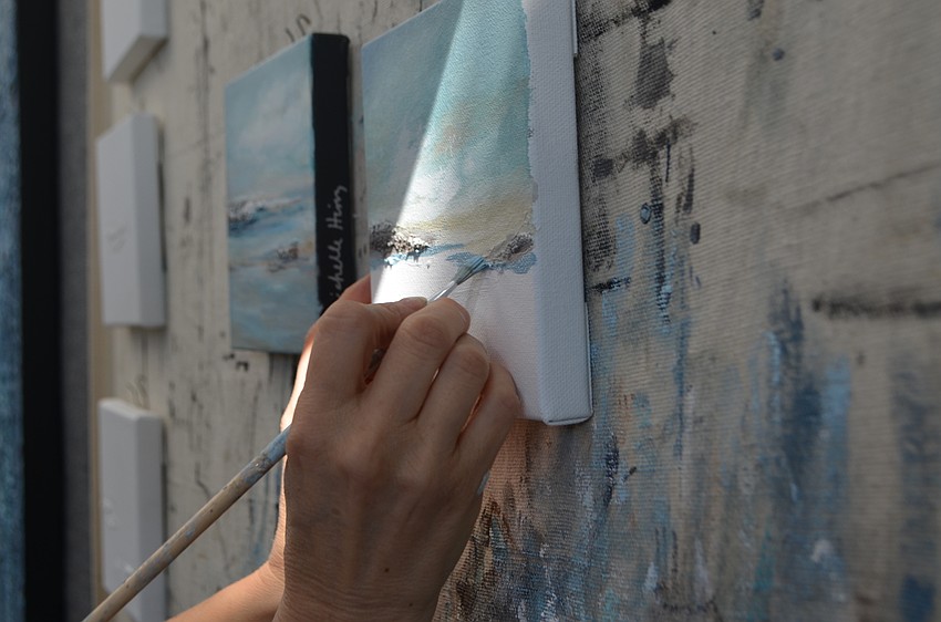 Michelle Hinz paints during the St. Armands Art Festival on Nov. 12.