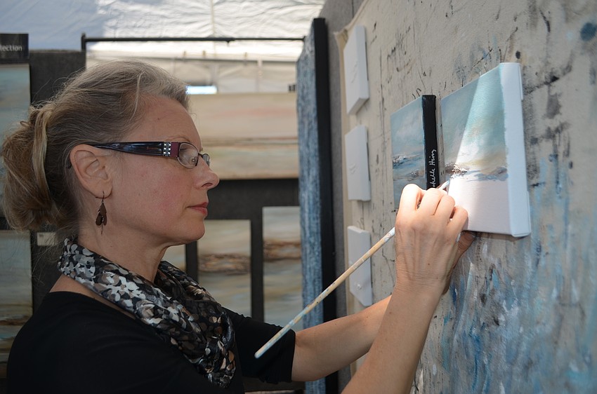 Michelle Hinz paints during the St. Armands Art Festival on Nov. 12.