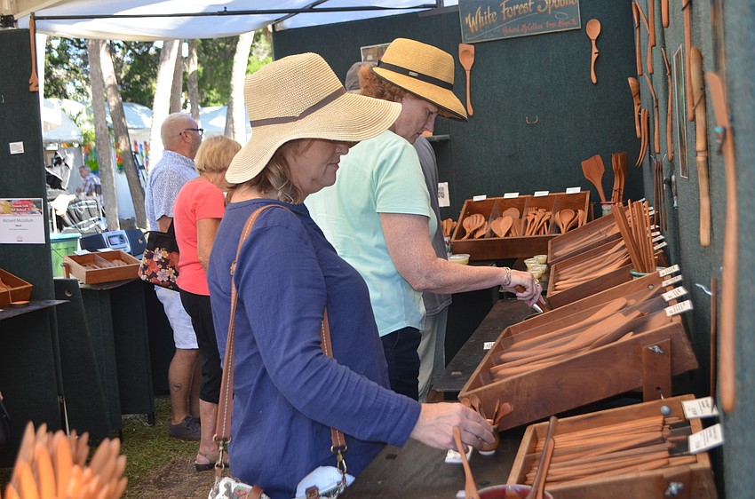 St. Armands Art Festival goers check out Richard McCollum’s White Forest Spoons.