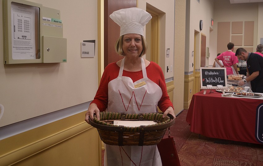 Maxine Solomon carried a basket of gift cards, which attendees could purchase for $20. Each gift card was worth $25 at a local restaurant and proceeds benefited the Friends of Gulf Gate Library.