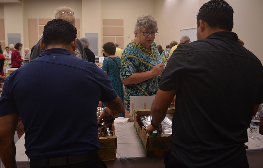 Jose Rojas and Artura Perez serve Taste of Gulf Gate attendees.