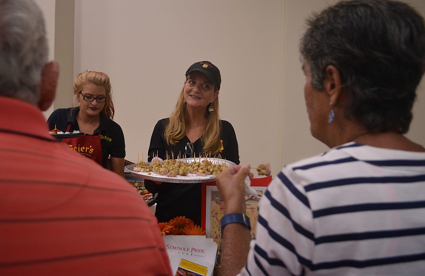 Caroline Martin and Kikita Egloff offer eventgoers samples from Geiers Sausage Kitchen.