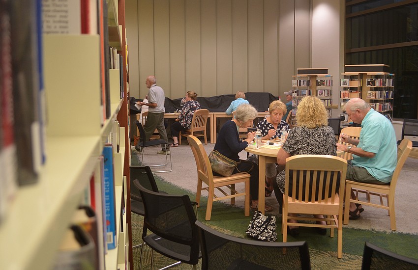 Sandra Gould, Linda Greco, Ed McKeever and Diane McKeever enjoy samples from 20 restaurants among the books at Gulf Gate Public Library.