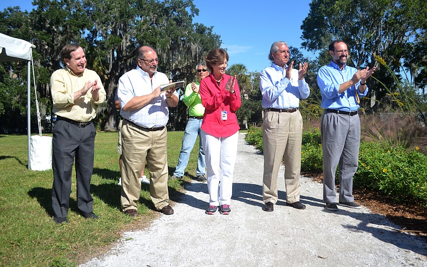 George Luer, Commission Alan Maio, Parks Director Carolyn Brown, Sarasota County Manager of Historical Resources Robert Bendus and New College Professor Uzi Baram clap after the ceremonial unveiling of the historical signs.