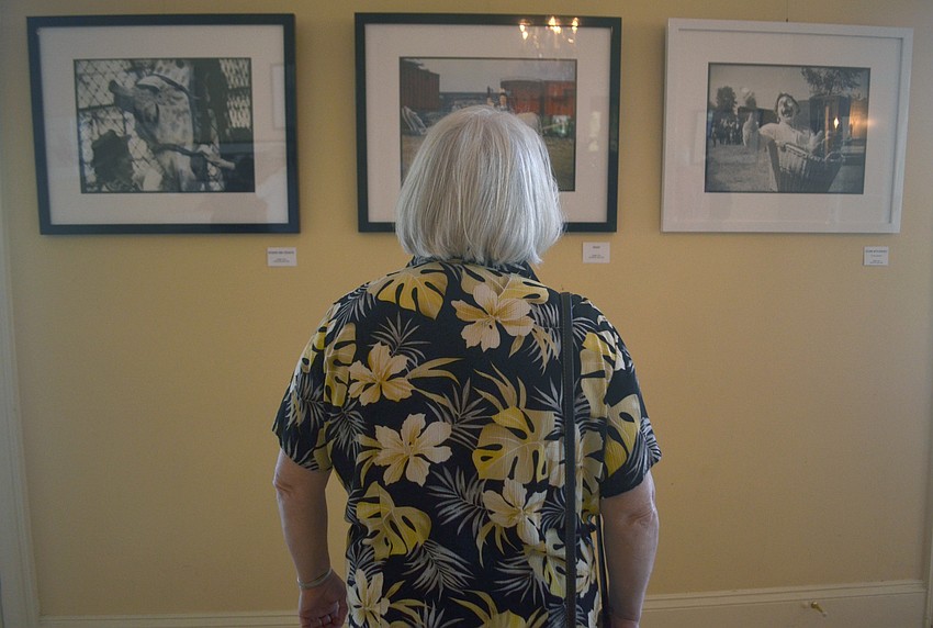 Audre Godanowski looks at photos from the backlots Ringling Circus. Part-time Siesta Key resident Elizabeth Siegfried found the photos in a box while cleaning out her family's cabin. The photos were taken by Siegfried's grandmother Elizabeth Chapin.