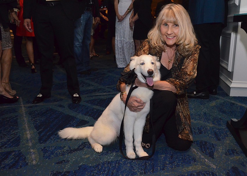 Ginny Armington with Happy, a 4-month-old white Siberian husky
